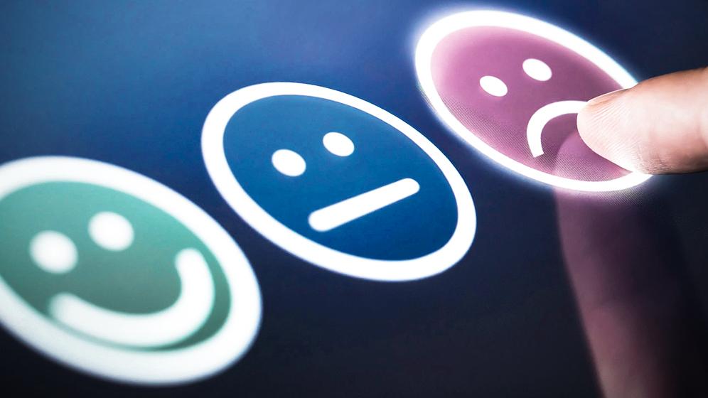 Drei Smiley, einer glücklich grün, einer neutral blau, einer unglücklich pink